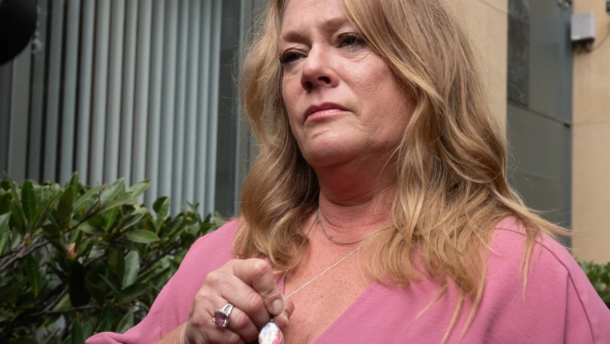 Victoria Hinks holds a locket with a picture of her 16-year old daughter Alexandra,